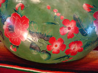 Mexican vintage folk art, a laquer-ware painted bowl, created from a gourd, from Chiapa de Curso, Chiapas, c. 1930. Closeup photo showing some of the floral decorations.