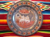 Mexican pottery and folk art, a lovely burnished charger by the late artist Amado Galvan, Tonala, Jalisco, c. 1960's. The charger features lovely deer and wonderful foliage, cactus, and flowers. Main photo.