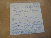 Mexican pottery and folk art, a lovely burnished charger by the late artist Amado Galvan, Tonala, Jalisco, c. 1960's. The charger features lovely deer and wonderful foliage, cactus, and flowers. Closeup photo of the inscription on the back of the plate.