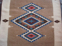 Mexican vintage textiles and sarapes, a lovely Texcoco runner, Texcoco, c. 1940's. The textile features beautiful natural wool colors with accents of indigo blue and cochineal red. Closeup photo of the center diamond.