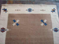 Mexican vintage textiles and sarapes, a lovely Texcoco runner, Texcoco, c. 1940's. The textile features beautiful natural wool colors with accents of indigo blue and cochineal red. Closeup photo of one corner of the Texcoco textile runner.