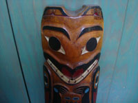 Native American Indian folk art and woodcarvings, a beautiful Northwest Coast large totem pole or house post, Haida, Queen Charlotte Islands, c. 1940's. Closeup photo of the face of the bear, at the top of the pole.