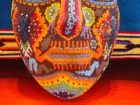 CI-13: Mexican vintage woodcarvings and masks, a beautiful beaded Huichol mask with very intricate and crisp design elements, the Sierras of Nyarite, c. 1950's. Closeup photo of the bottom part of the mask, near the mouth.