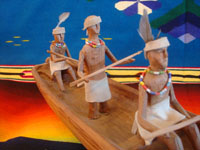 Native American Indian vintage folk art, a wonderful carved wooden canoe with Indians busilly paddling in search of some tasty salmon, Klamath or Karok, c. 1920. A photo shot from in front of the canoe looking back.