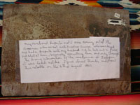Closeup photo of the back of the Mexican vintage exvoto painted on tin, giving an English translation of the text from the front of the exvoto.