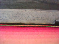Closeup photo of the text on the front of the Mexican vintage exvoto.