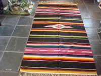 Mexican vintage textile, a Saltillo Sarape, c. 1940. Wonderfully woven of fine wool with silk in the center diamond and decorative side-bars.