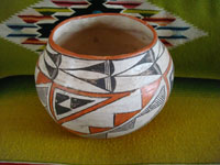 Native American Indian vintage pottery, an Acoma pot, c. 1960's. The pot is beautifully hand-painted with traditional Acoma geometric designs and is unsigned, indicating the age of the piece before artists began to regularly sign their pottery pieces. Another view of the Acoma pot.\