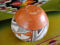 Native American Indian vintage pottery, an Acoma pot, c. 1960's. The pot is beautifully hand-painted with traditional Acoma geometric designs and is unsigned, indicating the age of the piece before artists began to regularly sign their pottery pieces. A photo showing the bottom of the Acoma pot.
