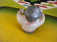 Native American Indian pottery or folk art, a storyteller attributed to Demasia Cordero, sister of the famous potter, Helen Cordero, and also famous in her own rite, c. 1940.  A photo giving a view of the back-side of the pottery piece.
