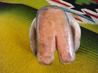 Native American Indian pottery or folk art, a storyteller attributed to Demasia Cordero, sister of the famous potter, Helen Cordero, and also famous in her own rite, c. 1940.  A photo of the bottom of the pottery piece.
