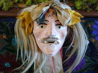 L-2: Mexican vintage wood-carving, a mask from the Michoacan "Dance of the old people" (Danza de los Viejitos), c. 1930's. Decorated with ribbons, horse-hair, and human teeth.