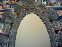 Mexican vintage tin-work, a closeup photo of the tin mirror.