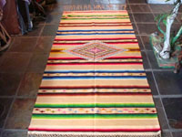 Mexican vintage textile, a Saltillo sarape, c. 1920. Woven of very fine wool with silk in the center diamond and side-bar decorations.  This is another photo of the entire Saltillo sarape.