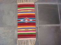 Mexican vintage textile, small Saltillo Sarape, c. 1940. Beautifully woven of fine wool with a silk center-diamond. Main photo.