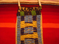 Native American Indian antique beadwork and folk-art, a Lakota (Sioux) beaded ration-pouch, c. 1890-1900. The beadwork on the pouch is very fine, and the pouch has a handle of lovely glass beads. Closeup photo of the front of the Lakota beadwork and leather ration pouch.