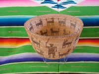 Native American Indian antique woven baskets and basket-weaving, a stunning Pima basket decorated with a figure of a man throwing a stick to his nineteen doggies, Pima, Arizona, c. 1915-20.  Main photo of the Pima basket.