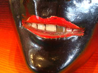 Mexican vintage woodcarvings and masks, and Mexican vintage folk art, a wonderful carved and painted wooden "Mask of the Negrito (Negro)", used in the dance in winter in San Lorenzo, Michoacan, c. 1950.  Closeup photo of the mouth of the mask, showing the brass tooth.