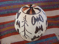 Wounaan Amazon Rain Forest woven basket decorated with wonderful butterflies and birds, Amazon Rain Forest, Panama, South America. Photo of the bottom of the Wounaan basket.