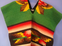 Mexican vintage textiles and sarapes, a beautiful child''s poncho with wonderful colors, Oaxaca, c. 1950's. Closeup photo of the front of the poncho.
