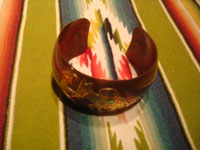 Mexican vintage jewelry, a wonderful copper bracelet with brass and abalone inlays, c. 1940's. Photo shot from above looking down at the bracelet.