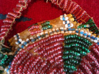 Native American Indian beaded pouch, Apache, c. 1850's. The pouch (probably a "ration pouch") has a wonderful handle and beaded flap. The beads are very small (including the "whities") and the beadwork is exquisite. Closeup photo of the beadwork.