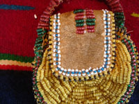 Native American Indian beaded pouch, Apache, c. 1850's. The pouch (probably a "ration pouch") has a wonderful handle and beaded flap. The beads are very small (including the "whities") and the beadwork is exquisite. Photo of the beaded flap on the front of the pouch.