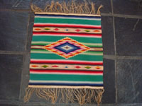 Mexican vintage textiles and sarapes, a wonderful Saltillo sarape with a fine center diamond, c. 1920. The center diamond and the decorative side-bars contain very fine silk. Main photo of sarape.