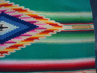 Mexican vintage textiles and sarapes, a wonderful Saltillo sarape with a fine center diamond, c. 1920. The center diamond and the decorative side-bars contain very fine silk. Photo of area to one side of the center medallion.