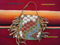 Native American Indian antique beadwork and folk art, a very finely beaded bag with some metallic beads, Plains, c. 1890-1900. The bag has a lovely checker-board pattern on one side, and a cross on the other.