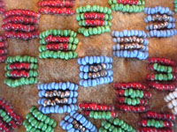 Native American Indian antique beadwork and folk art, a very finely beaded bag with some metallic beads, Plains, c. 1890-1900. The bag has a lovely checker-board pattern on one side, and a cross on the other. Closeup photo of the beadwork on the front of the pouch.
