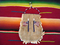 Native American Indian antique beadwork and folk art, a beautifully beaded Apache pouch (ration-ticket pouch), c. 1890. The ration pouch features two American flags on one side, and a wonderful checkerboard pattern on the other. Photo showing the American flags on one side of the beaded pouch.