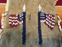 Native American Indian antique beadwork and folk art, a beautifully beaded Apache pouch (ration-ticket pouch), c. 1890. The ration pouch features two American flags on one side, and a wonderful checkerboard pattern on the other. A closeup photo of the two American flags on one side of the pouch.