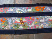 Mexican vintage textiles and sarapes, a beautifully woven and embroidered woman's skirt, Guerrero, 1940's. The long skirt, made to be wound around the waist and secured with a belt, is embroidered with wonderful animals, plants, and figures. Another closeup photo of embroidered figures on the skirt.