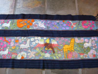 Mexican vintage textiles and sarapes, a beautifully woven and embroidered woman's skirt, Guerrero, 1940's. The long skirt, made to be wound around the waist and secured with a belt, is embroidered with wonderful animals, plants, and figures. Another closeup photo of the ebroidery.