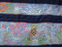 Mexican vintage textiles and sarapes, a beautifully woven and embroidered woman's skirt, Guerrero, 1940's. The long skirt, made to be wound around the waist and secured with a belt, is embroidered with wonderful animals, plants, and figures. Another closeup photo of the Guerrero skirt.