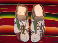 Native American Indian antique beadwork, a pair of Sioux (Lakota) beaded mocassins, c. 1890. The beadwork is exceptionally fine. The mocassins have a bi-furcated tongue. Main photo.
