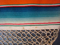 Mexican vintage textiles and sarapes, a lovely Saltillo sarape runner with a wonderful center design, c. 1940. Very beautifully woven of fine wool with silk in the center medallion and decorative side-bars. Closeup photo showing the minor stains on the sarape.
