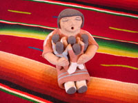 Native American Indian pottery and folk art, a story-teller from Jemez Pueblo with five children, signed B. Laretto, c. 1980. The grandmother's mouth is open, and the five children are obviously enthralled by her stories.