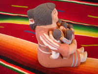 Native American Indian pottery and folk art, a story-teller from Jemez Pueblo with five children, signed B. Laretto, c. 1980. The grandmother's mouth is open, and the five children are obviously enthralled by her stories. A side-view of the story teller.