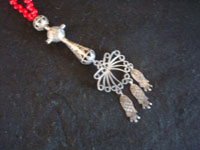 Mexican vintage sterling silver jewelry, and Purepecha (called Tarascans by Spanish conquerers) ceremonial sterling silver jewelry, a Purepecha necklace with silver and red glass beads, Michoacan, c. 1950.  Closeup photo of the pendant at the base of the necklace.