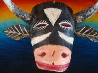 Mexican vintage woodcarvings and masks, a wonderful wooden mask depicting and animated and charming bull, or Torito, Michoacan, c. 1940's.  Closeup photo of the bull's head.