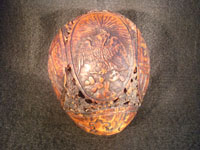 Mexican vintage folk art, a finely carved coconut with scenes from the Mexican Revolution of 1910, c. 1925-35. The carved coconut has the Mexican national emblem of the eagle and snake inlaid in abalone. Photo of Mexican eagle and snake on coconut.