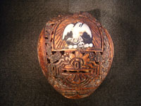 Mexican vintage folk art, a finely carved coconut with scenes from the Mexican Revolution of 1910, c. 1925-35. The carved coconut has the Mexican national emblem of the eagle and snake inlaid in abalone. Photo of Mexican flag inlaid in abolone.