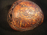 Mexican vintage folk art, a finely carved coconut with scenes from the Mexican Revolution of 1910, c. 1925-35. The carved coconut has the Mexican national emblem of the eagle and snake inlaid in abalone. Photo of revolutionaries celebrating at table.