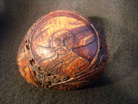 Mexican vintage folk art, a finely carved coconut with scenes from the Mexican Revolution of 1910, c. 1925-35. The carved coconut has the Mexican national emblem of the eagle and snake inlaid in abalone. Photo of Zapata on carved coconut.
