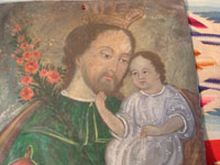 Mexican vintage devotional art, a retablo of Saint Joseph with the child Jesus painted on tin, c. 1870-1900. The colors are vibrant and the artwork is exceptional! Closeup photo of Saint Joseph and the child Jesus.