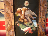 Mexican vintage folk art, a feather-work picture of an eagle with the Mexican flag, c. 1920. This picture of the eagle with the Mexican flag is done with hundreds of tiny feathers of many colors. Featherwork pictures are a wonderful artform originating in Mexico in pre-Hispanic times. Another closeup photo of eagle.