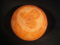 Native American Indian antique basket, Mission basket with original sales tag, 1918. Very finely woven Mission basket with the original sales tag from c. 1918. Various shades of juncus on a deer grass bundle; very tightly coiled. The original sales tag identifies this basket as from the Saboba Reservation, Riverside, California, 1918. The other side of the tag identifies the basket as coming from a Marvin Whitaker of Portland, Oregon, the dealer or original collector. Condition is excellent. Closeup of bottom of Mission basket.