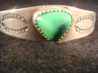 Native American Indian vintage silver jewelry, a Navajo silver bracelet with ingot silver and a beautiful turquoise stone, c. 1920.  Closeup photo of Navajo silver bracelet.